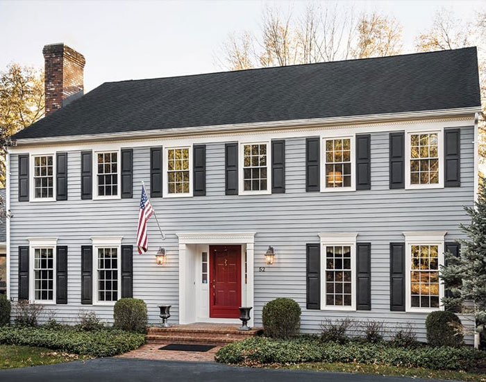 light blue house with windows and shutters