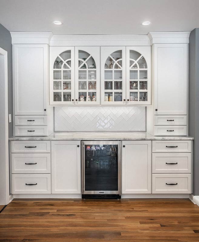 wine fridge surrounded by white cabinetry