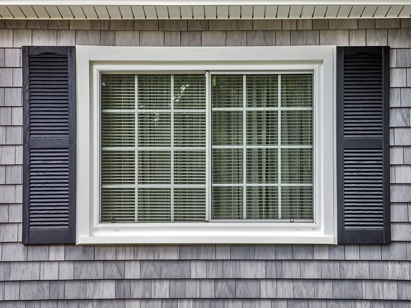 white window with dark shutters