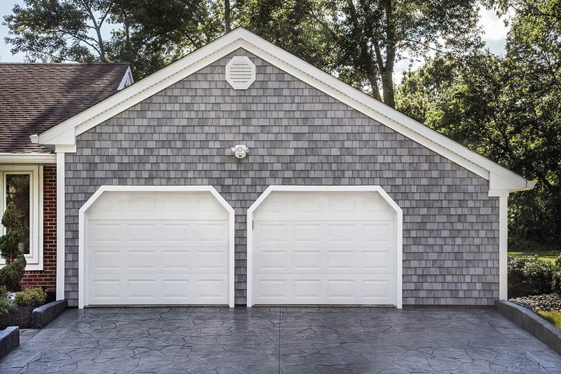 garage with gray shaker siding