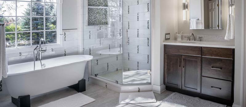 bathroom with walk in shower and tub
